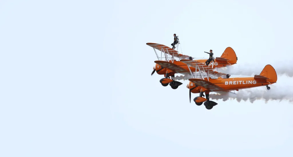 Wing walker performing on an aerobatic plane