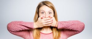 Woman covering her mouth with both hands