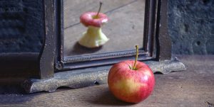 Apple viewed through a magnifying glass, illustrating perception and perspective