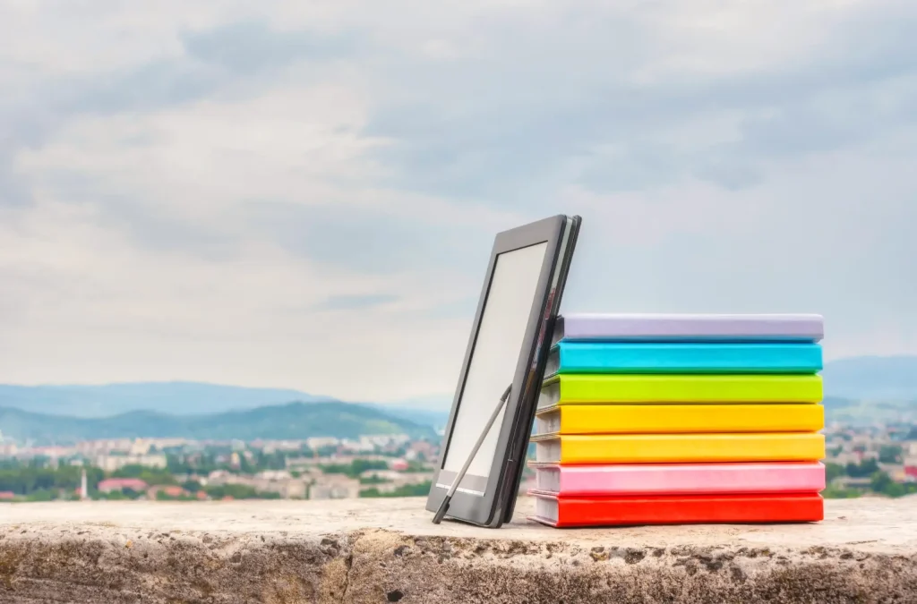 Colour-coded folders arranged beside a tablet