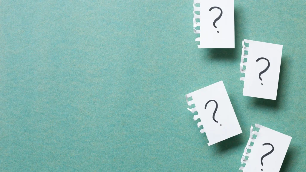 Paper notes with question marks