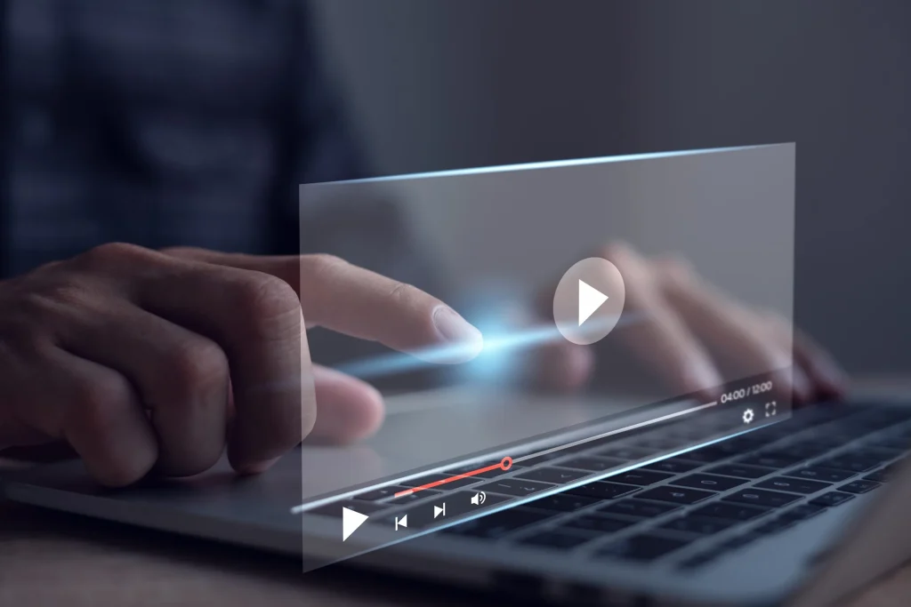 Person using video controls on a laptop