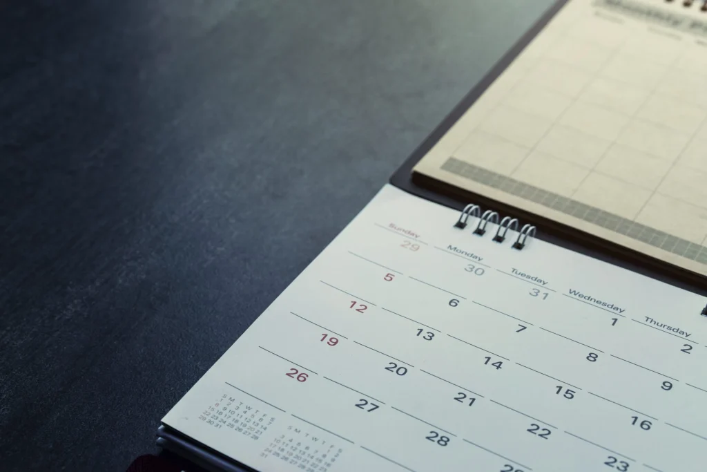 Desk calendar open to a monthly schedule